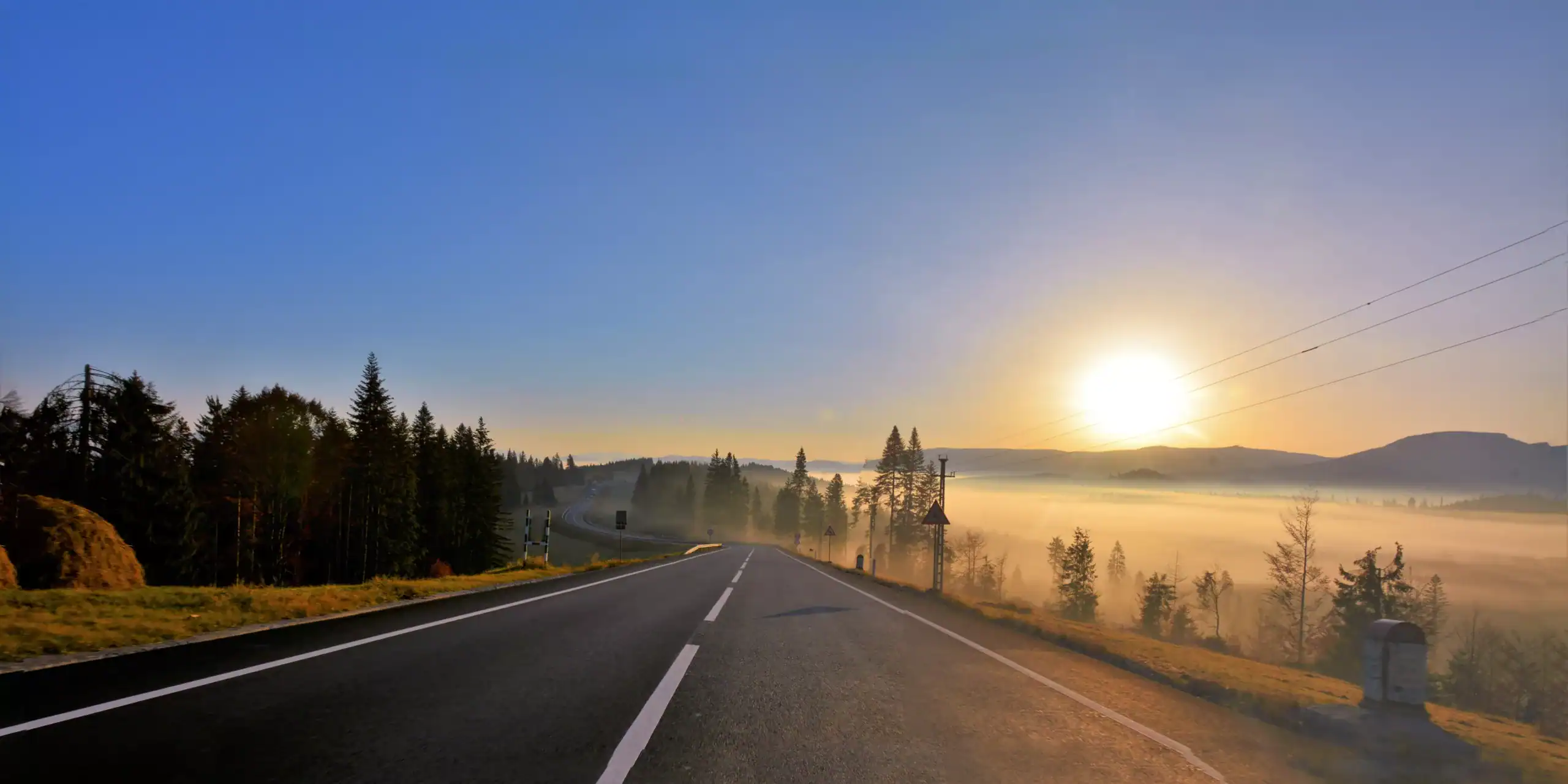 Asphalt road at sunset