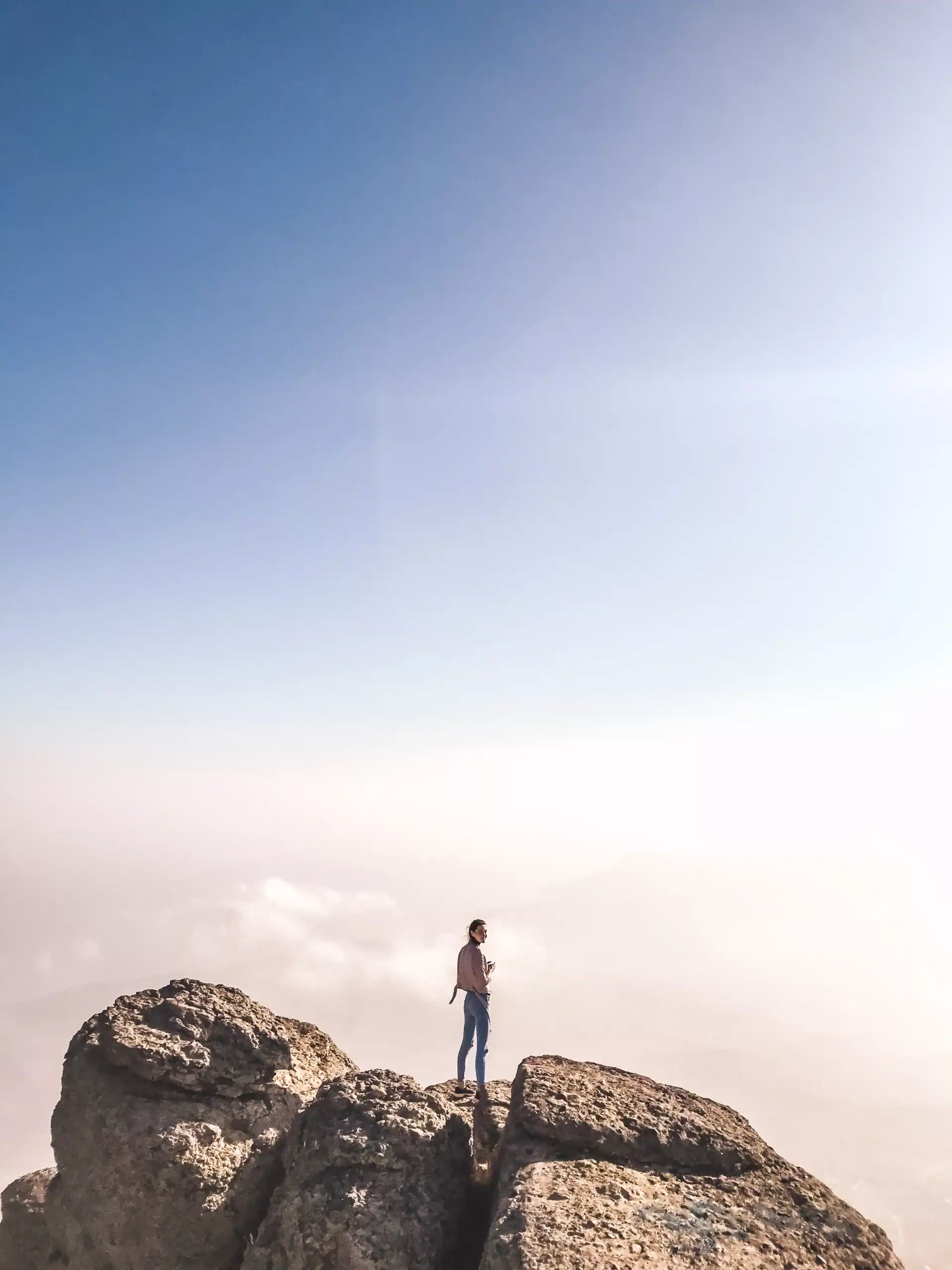 A girl standing on the top of a mountain over the 2026 03 13 05 26 08 utc